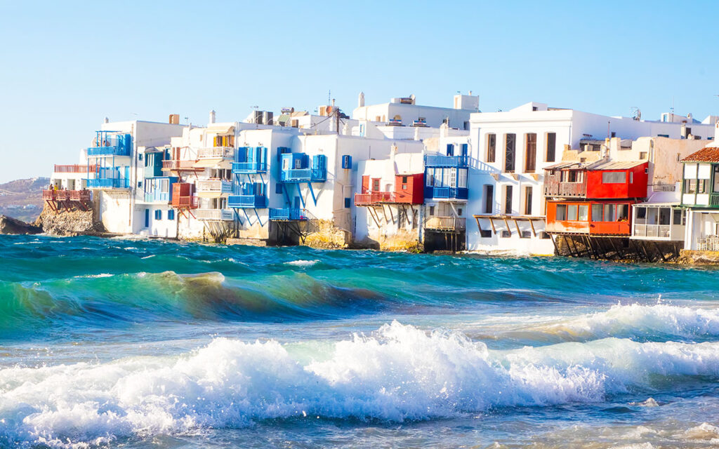 Discovering Mykonos: A Guide to the Island's Top Attractions - Iconic Mykonos Windmills Against Blue Sky - Mykonos Lighthouse Overlooking the Aegean Sea